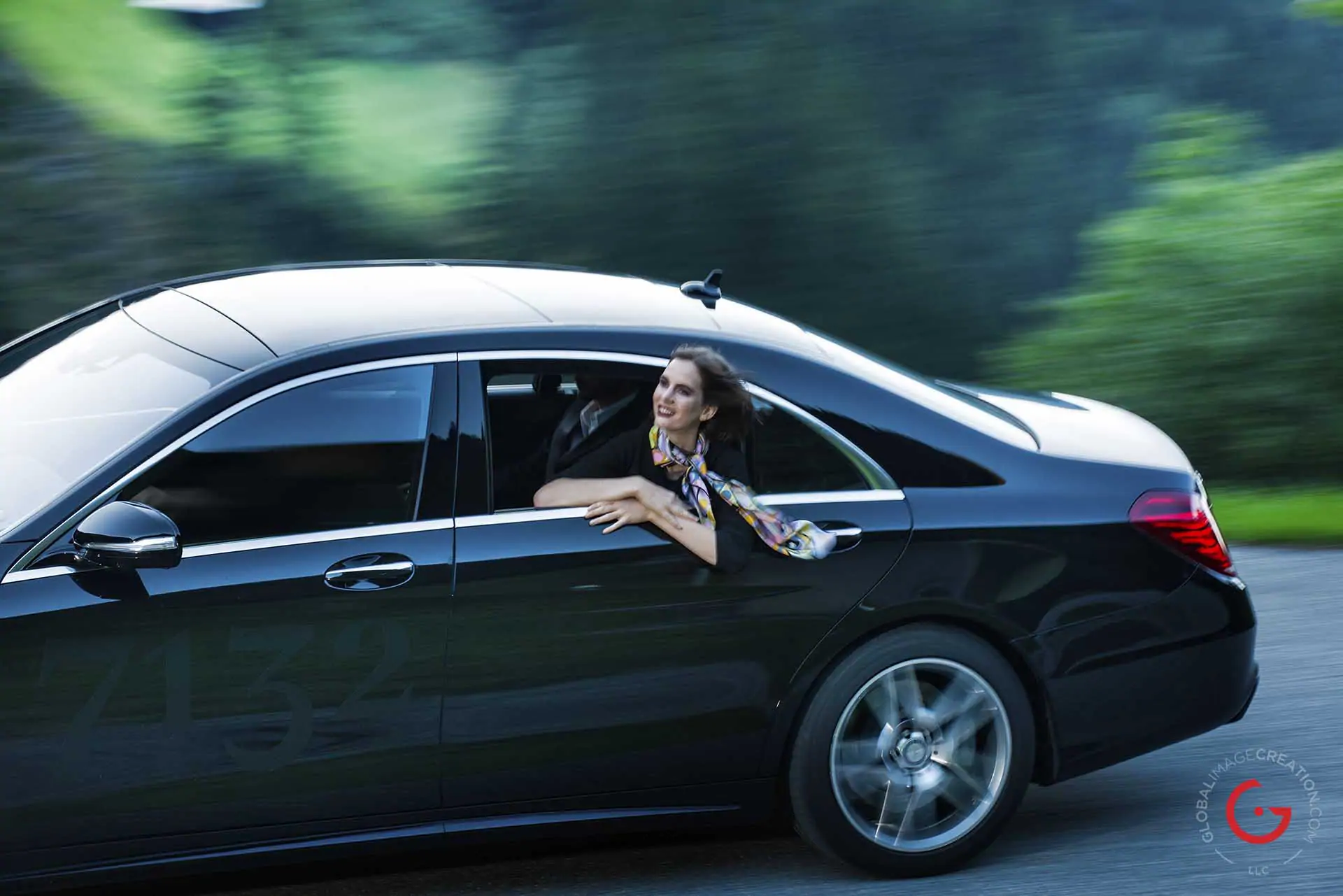 Woman enjoys the view from her limo while driving in the mountains - Photographer Lifestyle Photography Wardrobe Stylist