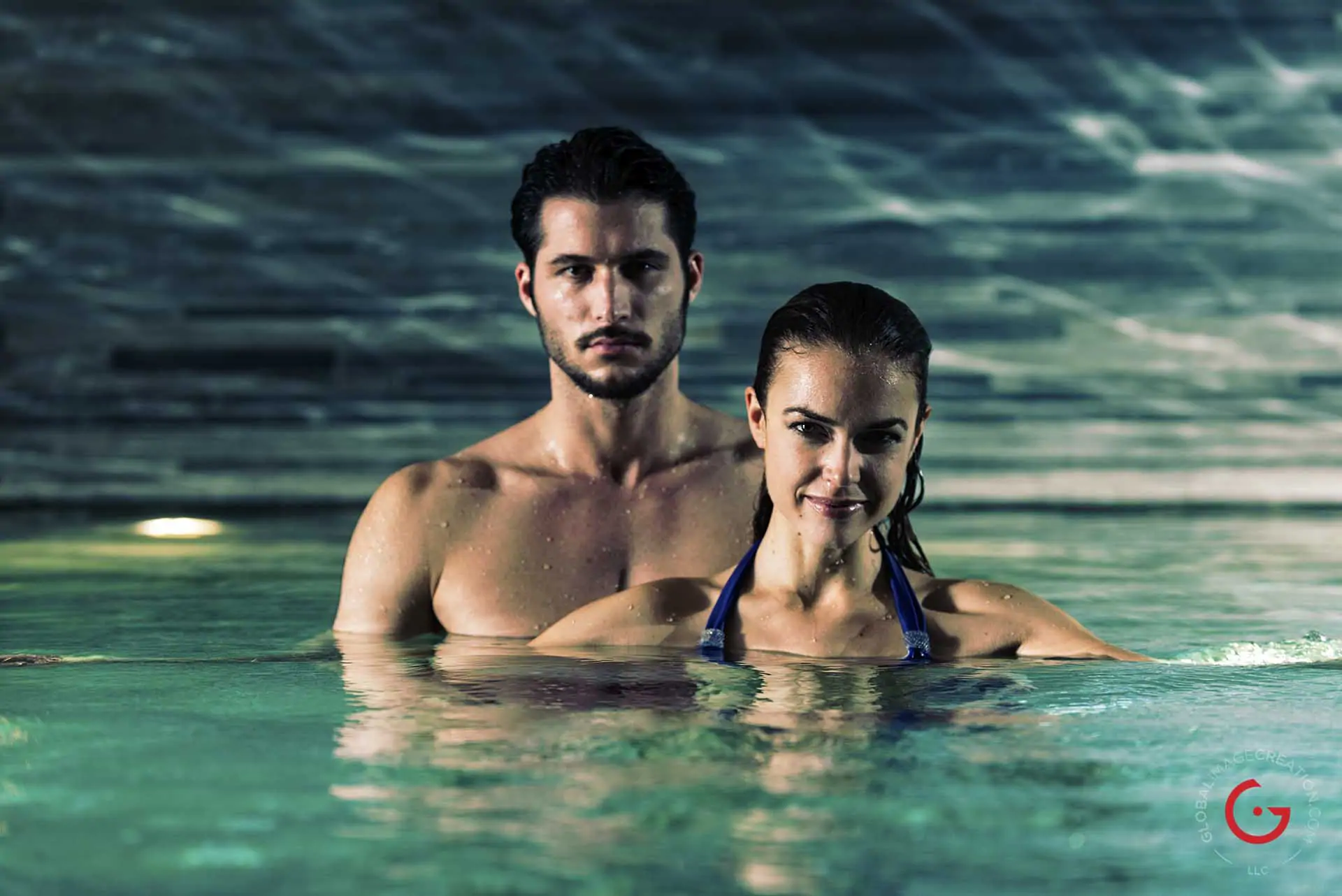 Romantic couple in the warm water of the Peter Zumthor Therme at 7132 Hotel in Vals - Professional Photographer Lifestyle Photography Wardrobe Stylist
