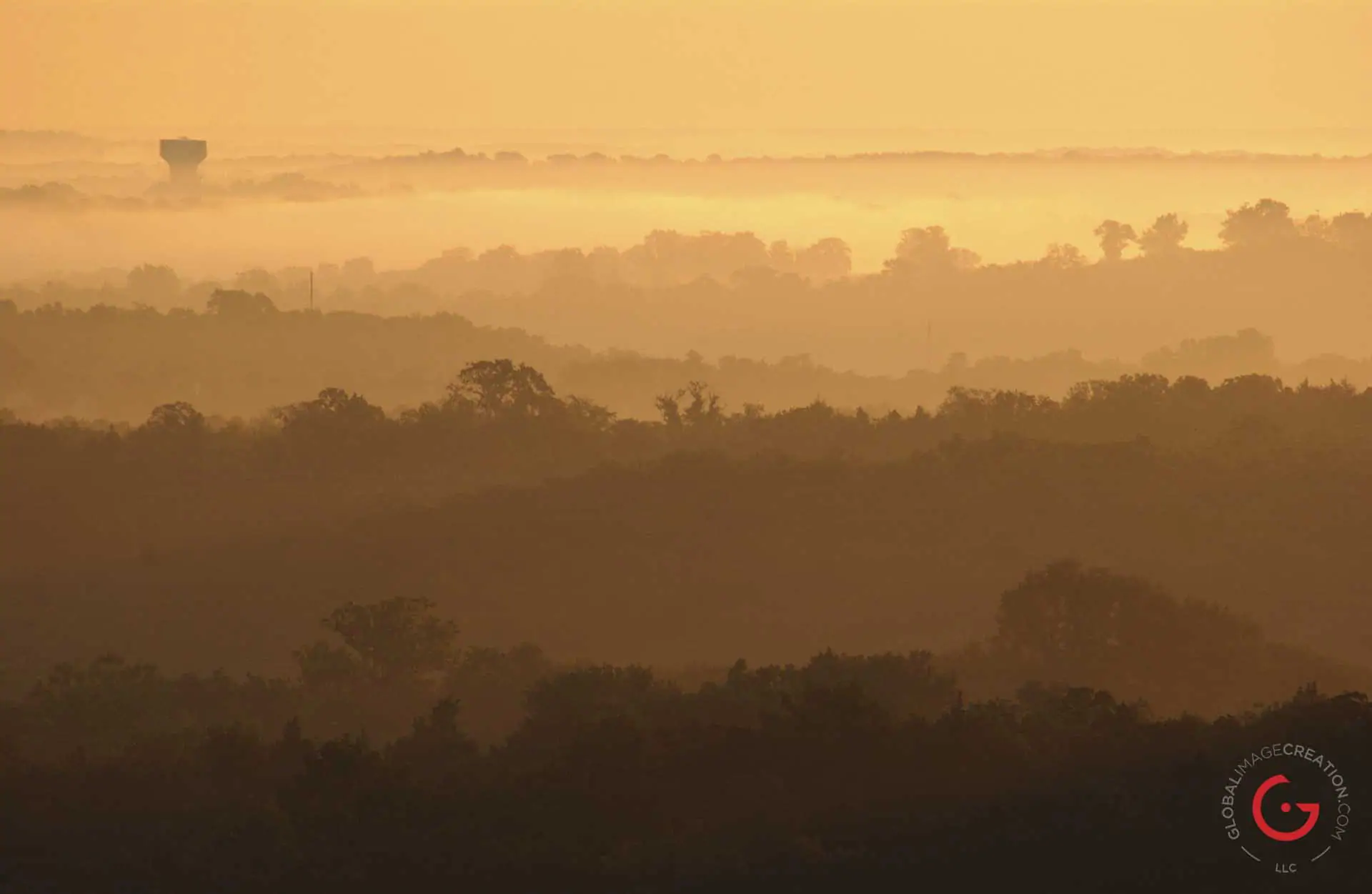 Ozark mountain hills in the morning fog. Golden sun illuminates the cut paper hills. - Advertising photographers in Branson Missouri, Branson Missouri photography