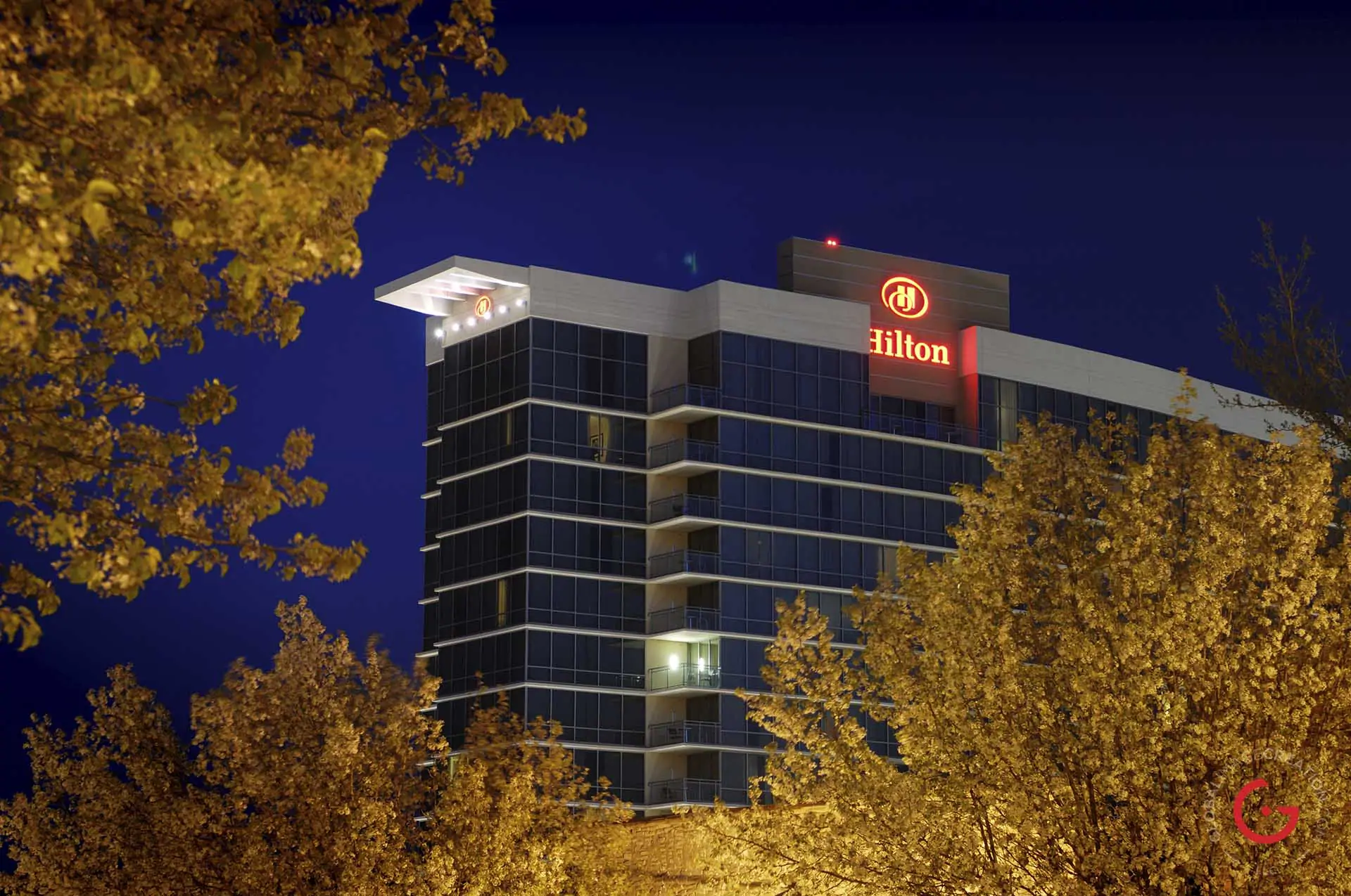 Branson Hilton Convention Center Hotel framed by fall leaves in the night sky. - Advertising photographers in Branson Missouri, Branson Missouri photography
