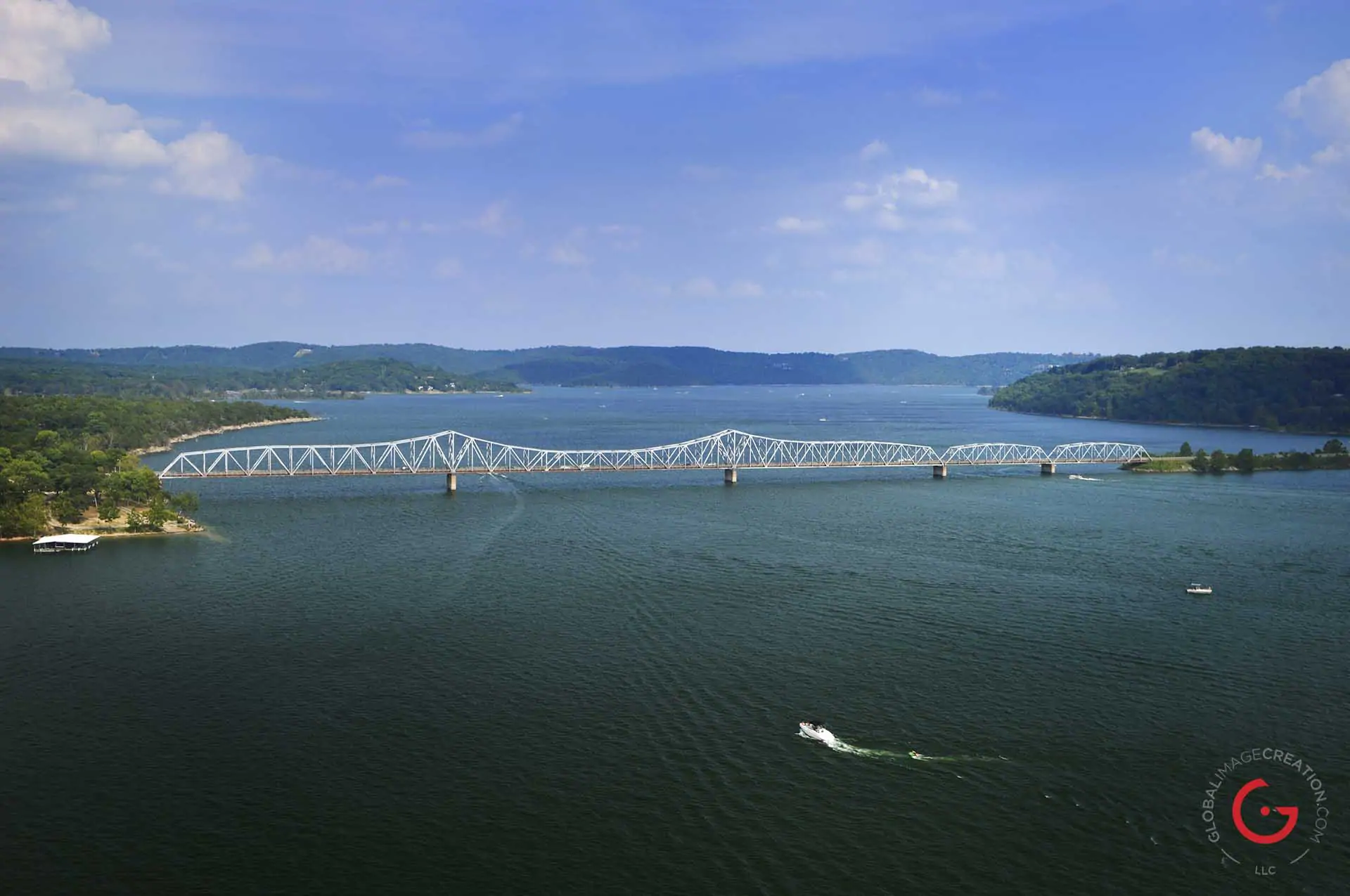 Aerial view of a boat approaching the Kimberling City bridge on table rock lake.
