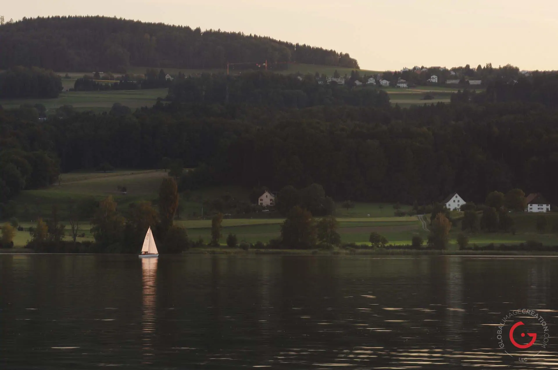 Lone Sailboat on the Lake - Travel Photographer and Switzerland Photography